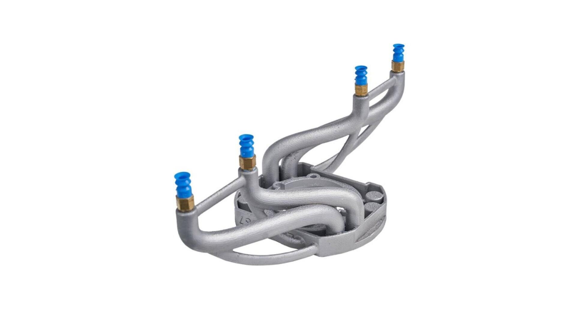 A metallic, curved manifold with four branching pipes, each ending in a blue and gold connector, is displayed against a white background.