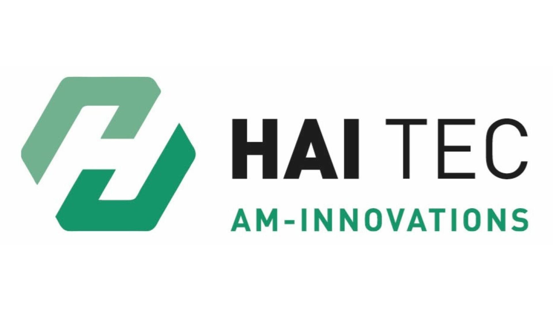 Logo for HAI TEC AM-INNOVATIONS featuring an abstract green geometric hexagon design on the left, and the company name in bold black and green text on the right.