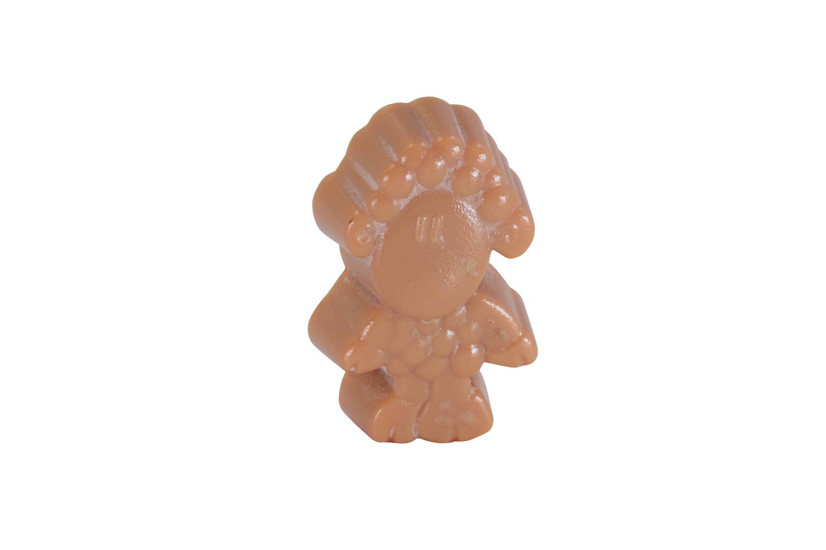 A small, brown, plastic toy figure with a round face, textured hair, and simplified features, standing upright against a plain white background.